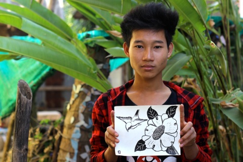 A student with his finished ink drawing from the workshop.